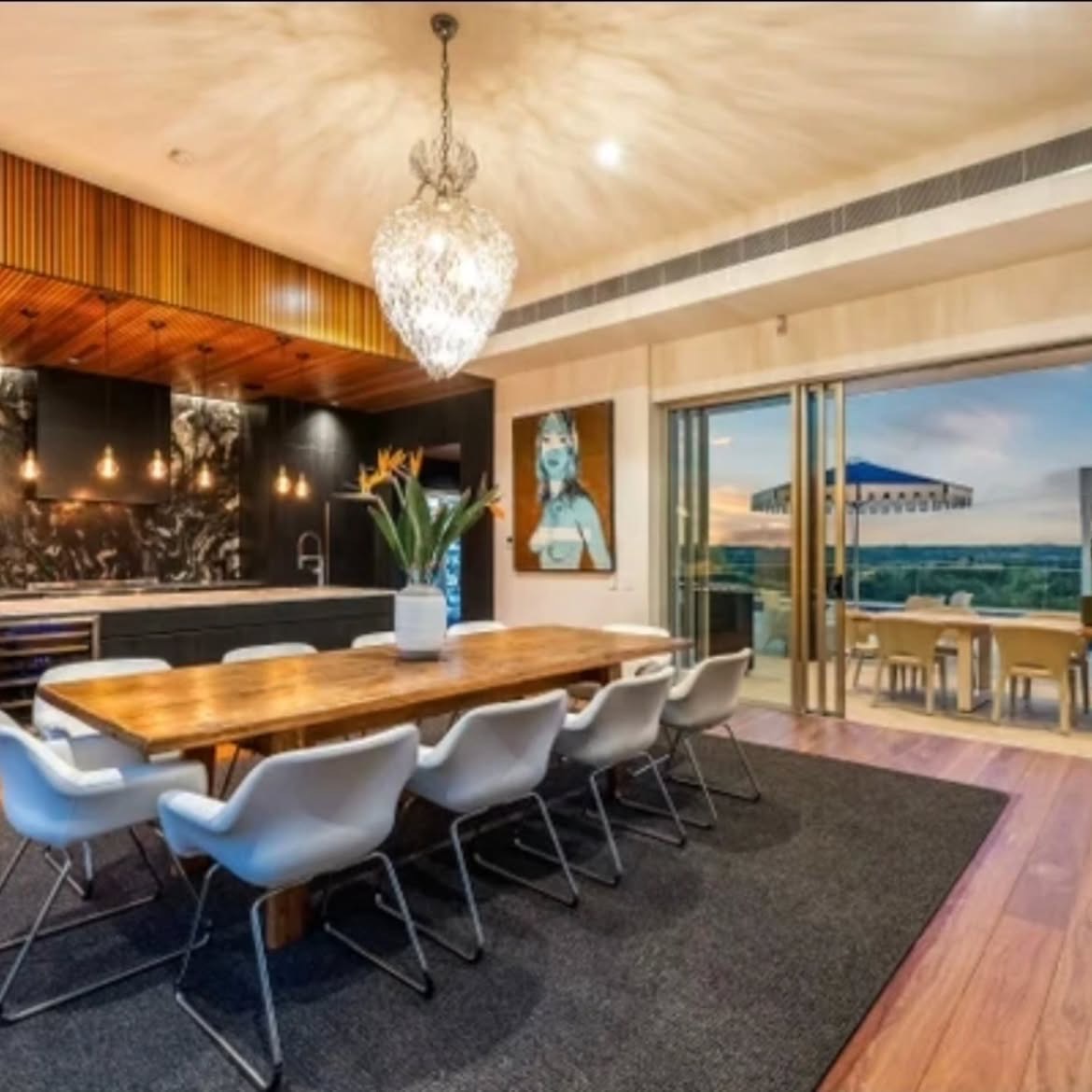 Open-plan kitchen and dining with timber and sunset views